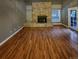Living room with hardwood floors, gas fireplace, and access to patio at 442 S Kalispell Way # C, Aurora, CO 80017
