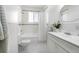 Bathroom featuring an updated shower, tub, sink, and white tile floor at 7996 Bradburn Blvd, Westminster, CO 80030