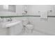 Bright bathroom features tiled walls and floors, and pedestal sink at 7996 Bradburn Blvd, Westminster, CO 80030