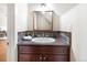 Charming half-bathroom with a stone tile backsplash, updated vanity, and framed mirror at 7996 Bradburn Blvd, Westminster, CO 80030
