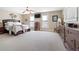 Spacious bedroom with natural light, ceiling fan, TV, and dark wood furnishings at 7996 Bradburn Blvd, Westminster, CO 80030