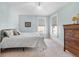 Bedroom featuring light blue walls, neutral carpet, modern windows, and antique dresser at 7996 Bradburn Blvd, Westminster, CO 80030
