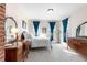 Bright bedroom features neutral carpet, plenty of natural light and antique furniture pieces at 7996 Bradburn Blvd, Westminster, CO 80030