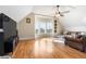 Comfortable bonus room featuring hardwood floors, natural light, and a leather sofa at 7996 Bradburn Blvd, Westminster, CO 80030