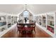 Bright dining room features hardwood floors, custom shelving, and a long table at 7996 Bradburn Blvd, Westminster, CO 80030