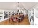 Bright dining room features hardwood floors, custom shelving, and a long table at 7996 Bradburn Blvd, Westminster, CO 80030