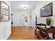 Inviting hallway with wood floors and vintage accent table at 7996 Bradburn Blvd, Westminster, CO 80030