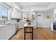 Bright kitchen features white cabinets, stainless steel appliances, and a butcher block island at 7996 Bradburn Blvd, Westminster, CO 80030