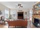 Bright living room with a decorative fireplace, hardwood floors, and natural light from large windows at 7996 Bradburn Blvd, Westminster, CO 80030