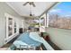 Relaxing covered porch with outdoor seating, ceiling fans, and natural light at 7996 Bradburn Blvd, Westminster, CO 80030