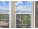 Bright windows with scenic views of mountains and trees, filling the space with natural light at 7996 Bradburn Blvd, Westminster, CO 80030