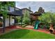 Spacious backyard featuring a custom playhouse and slide for outdoor fun at 1175 Oakhurst Dr, Broomfield, CO 80020