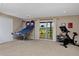 Spacious room with exercise equipment, closet, and backyard access to the fire pit, creating a versatile space at 1175 Oakhurst Dr, Broomfield, CO 80020