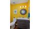 Unique powder room featuring vibrant yellow walls, stylish vanity, and decorative mirror at 1175 Oakhurst Dr, Broomfield, CO 80020