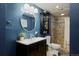 Stylish bathroom featuring modern fixtures, circular mirror, and tiled shower at 1175 Oakhurst Dr, Broomfield, CO 80020