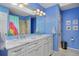 Bright bathroom featuring a dual sink vanity with marble counters, framed mirrors, and stylish decor at 1175 Oakhurst Dr, Broomfield, CO 80020