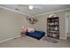 Bedroom featuring comfortable single bed and whimsical stuffed animal storage in a neutral toned room at 1175 Oakhurst Dr, Broomfield, CO 80020