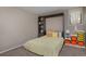 Cozy bedroom with built-in shelving, ample storage, and a comfortable Murphy bed at 1175 Oakhurst Dr, Broomfield, CO 80020
