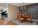 Elegant dining room featuring hardwood floors, patterned wallpaper, and a stylish light fixture at 1175 Oakhurst Dr, Broomfield, CO 80020