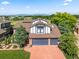 Charming two-story home with a three-car garage, lush landscaping, and mountain views in the background at 1175 Oakhurst Dr, Broomfield, CO 80020