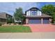 Inviting two-story home with a three-car garage, a well-kept lawn, and mature trees at 1175 Oakhurst Dr, Broomfield, CO 80020