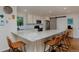 Well-appointed kitchen with stainless steel appliances, granite counters, and a sliding barn door at 1175 Oakhurst Dr, Broomfield, CO 80020