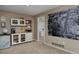 View of the basement kitchenette with a minibar, storage and access to the adjacent basement and bathroom at 1175 Oakhurst Dr, Broomfield, CO 80020