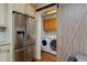 Convenient laundry room with modern appliances and a stylish barn door, adjacent to the kitchen at 1175 Oakhurst Dr, Broomfield, CO 80020
