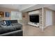 Cozy living room features a plush sofa, a wall-mounted TV, and ambient lighting, perfect for relaxing at 1175 Oakhurst Dr, Broomfield, CO 80020
