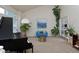 Airy living room with a grand piano, comfortable seating, and plenty of natural light at 1175 Oakhurst Dr, Broomfield, CO 80020