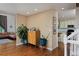 Inviting living room space featuring hardwood floors and a modern bar cabinet at 1175 Oakhurst Dr, Broomfield, CO 80020
