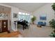 Bright living room featuring high ceilings, large windows, a grand piano, and stylish decor at 1175 Oakhurst Dr, Broomfield, CO 80020