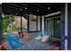 Cozy covered patio with unique blue chairs and ambient string lights at 1175 Oakhurst Dr, Broomfield, CO 80020