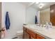 Bathroom features a large mirror over the sink and a partially visible shower behind a curtain at 14093 E Radcliff Cir, Aurora, CO 80015