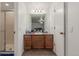 Bathroom vanity featuring a large mirror, updated lighting and stylish tile at 14093 E Radcliff Cir, Aurora, CO 80015