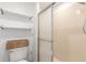 Updated bathroom featuring a glass shower, modern toilet and ample storage at 14093 E Radcliff Cir, Aurora, CO 80015