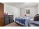 Simple bedroom with neutral walls, carpet and a black dresser at 14093 E Radcliff Cir, Aurora, CO 80015