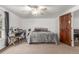 Cozy bedroom featuring a ceiling fan, neutral carpet and a warm color palette at 14093 E Radcliff Cir, Aurora, CO 80015