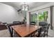 Inviting dining area featuring a rustic wood table and a stylish light fixture at 14093 E Radcliff Cir, Aurora, CO 80015