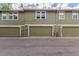 Exterior shot of townhomes showcasing garage doors, windows and overall facade at 14093 E Radcliff Cir, Aurora, CO 80015