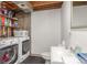Laundry area with side-by-side washer and dryer, toilet, and small sink; also has shelving units with storage at 14093 E Radcliff Cir, Aurora, CO 80015