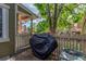 Charming patio with wood fence featuring mature trees, an outdoor grill, and view of the neighborhood at 14093 E Radcliff Cir, Aurora, CO 80015