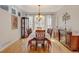 Elegant dining room with wood furniture, a large window, and hardwood floors at 17613 E Peakview Ave, Aurora, CO 80016