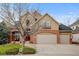 Charming two-story home featuring a brick facade, inviting entrance, and a spacious three-car garage at 17613 E Peakview Ave, Aurora, CO 80016