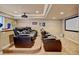 This home theater has tiered seating, a projector, and a large screen at 17613 E Peakview Ave, Aurora, CO 80016
