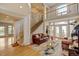Bright, open living room with a grand staircase and large windows showcasing natural light at 17613 E Peakview Ave, Aurora, CO 80016