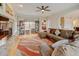 Open living room with a fireplace, large windows, and hardwood floors throughout at 17613 E Peakview Ave, Aurora, CO 80016