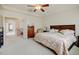 Bright main bedroom featuring a tray ceiling, neutral color palette, and an ensuite bathroom at 17613 E Peakview Ave, Aurora, CO 80016