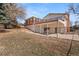 Image displaying the home's backyard featuring a sunroom, garage, and patio area at 2799 S Ingalls Way, Denver, CO 80227