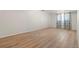 Spacious bedroom with laminate flooring, light walls, and modern curtains at 2799 S Ingalls Way, Denver, CO 80227